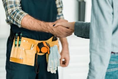 two people shaking hands and discussing Certificate Of Insurance Tracking Services